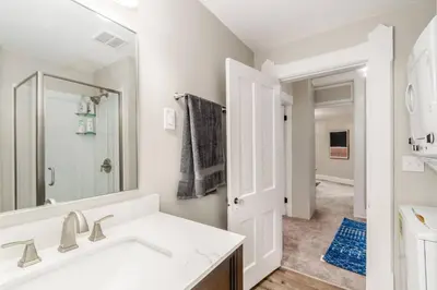 a white bathroom with a sink and a mirror at Short north- STEPS to High St -Private Parking-OSU in Columbus