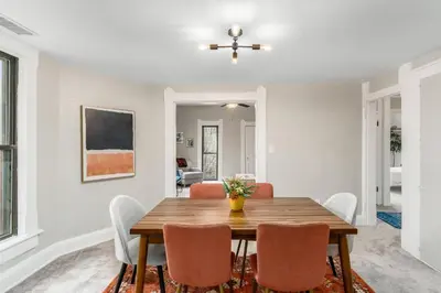 a dining room with a wooden table and chairs at Short north- STEPS to High St -Private Parking-OSU in Columbus