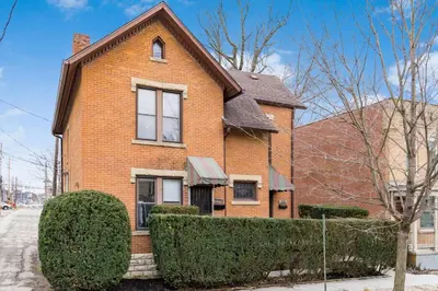a brick house with bushes in front of it at Short north- STEPS to High St -Private Parking-OSU in Columbus