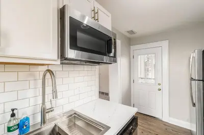 a kitchen with a sink and a microwave at Short north- STEPS to High St -Private Parking-OSU in Columbus
