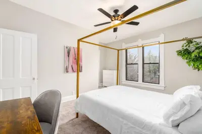 a bedroom with a bed and a ceiling fan at Short north- STEPS to High St -Private Parking-OSU in Columbus