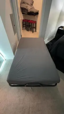 a bed sitting on the floor in a room at The 513 Flat! 1BR, 1Bath Apt with Pool and Riverfront View! Free Gated Parking! Only Steps from The banks & Stadiums! in Cincinnati