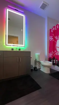 a bathroom with a toilet and a large mirror at The 513 Flat! 1BR, 1Bath Apt with Pool and Riverfront View! Free Gated Parking! Only Steps from The banks & Stadiums! in Cincinnati
