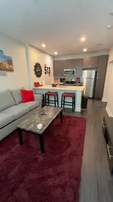a living room with a couch and a table at The 513 Flat! 1BR, 1Bath Apt with Pool and Riverfront View! Free Gated Parking! Only Steps from The banks & Stadiums! in Cincinnati
