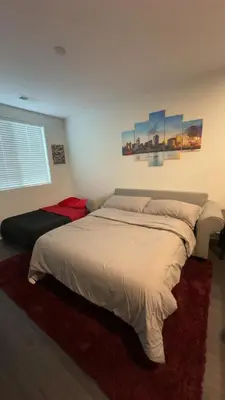 a bedroom with a large bed in a room at The 513 Flat! 1BR, 1Bath Apt with Pool and Riverfront View! Free Gated Parking! Only Steps from The banks & Stadiums! in Cincinnati