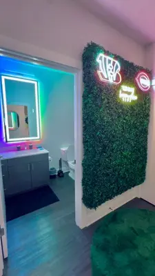 a bathroom with a green wall in a room at The 513 Flat! 1BR, 1Bath Apt with Pool and Riverfront View! Free Gated Parking! Only Steps from The banks & Stadiums! in Cincinnati