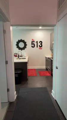 a kitchen with a sink and a counter with a sign on the wall at The 513 Flat! 1BR, 1Bath Apt with Pool and Riverfront View! Free Gated Parking! Only Steps from The banks & Stadiums! in Cincinnati