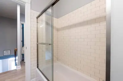 a glass shower in a bathroom with a tub at Luxury Chefs Kitchen - OSU/Short North - Sleeps 10 in Columbus