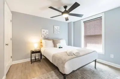 a bedroom with a bed with a ceiling fan at Luxury Chefs Kitchen - OSU/Short North - Sleeps 10 in Columbus
