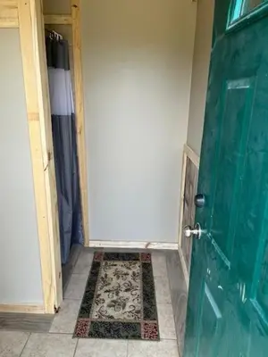 a room with a green door and a tile floor at RV Camper in New Lexington