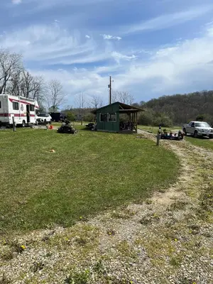 a grassy field with a building in the background at RV Camper in New Lexington