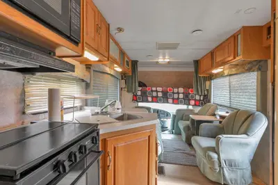 a kitchen and dining area of an rv at RV Camper in New Lexington
