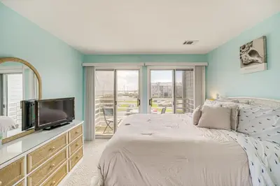 a bedroom with a large bed and a tv at 1 Mi to Ferry Port Clinton Condo with Beach View! in Port Clinton