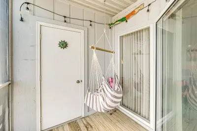 a room with a door and a hammock next to a window at 1 Mi to Ferry Port Clinton Condo with Beach View! in Port Clinton