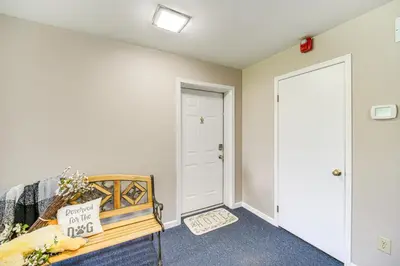 a room with a bed and a white wall at 1 Mi to Ferry Port Clinton Condo with Beach View! in Port Clinton