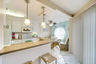 a kitchen with a counter and a dining room at 1 Mi to Ferry Port Clinton Condo with Beach View! in Port Clinton
