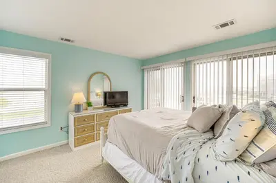 a bedroom with blue walls and a bed and a television at 1 Mi to Ferry Port Clinton Condo with Beach View! in Port Clinton