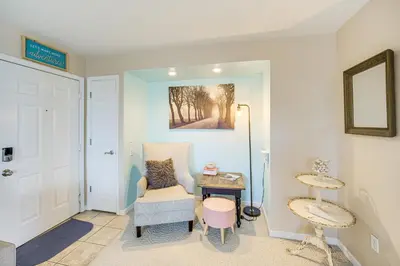 a living room with a chair and a table at 1 Mi to Ferry Port Clinton Condo with Beach View! in Port Clinton