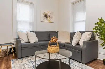 a living room with a gray couch and a table at Steps 2 High ST - BIG Patio - Private parking- OSU in Columbus