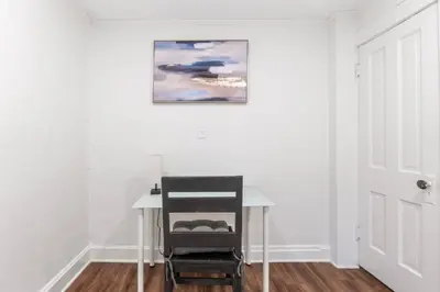 a desk in a room with a painting on the wall at Steps 2 High ST - BIG Patio - Private parking- OSU in Columbus
