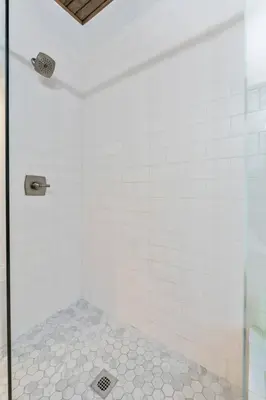 a bathroom with a shower with white tiles at Steps 2 High ST - BIG Patio - Private parking- OSU in Columbus