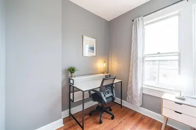a home office with a desk and a window at Cozy Brick-Short North Condo - (fenced yard) - OSU in Columbus