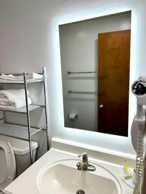 a bathroom with a sink and a mirror at Travelodge by Wyndham Gallipolis in Gallipolis