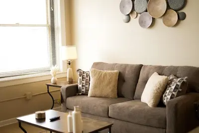 a living room with a couch and a table at Delightful Downtown Free parking in Cleveland