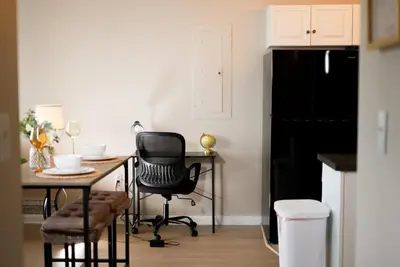 a kitchen with a table and a black refrigerator at Delightful Downtown Free parking in Cleveland