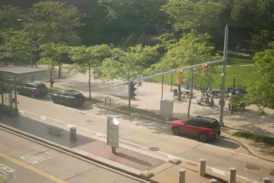 a red car is parked at a street intersection at Delightful Downtown Free parking in Cleveland