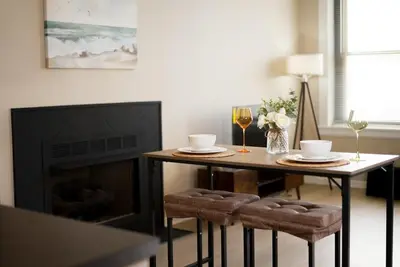 a living room with a table and a fireplace at Delightful Downtown Free parking in Cleveland