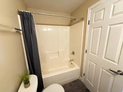 a bathroom with a shower and a white toilet at Delightful Downtown Free parking in Cleveland