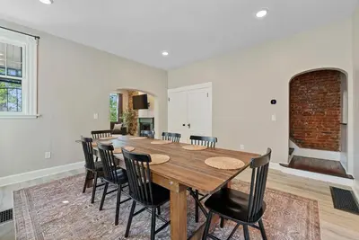 a dining room with a wooden table and chairs at Perfect location-Short North home HUGE4-car garage in Columbus