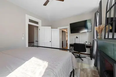 a bedroom with a bed and a flat screen tv at Perfect location-Short North home HUGE4-car garage in Columbus