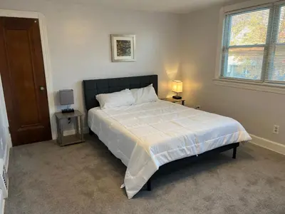 a bedroom with a large bed and a window at Cleveland Airport - 2nd Floor - WonDos Apartment in Cleveland