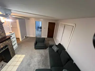 a living room with a couch and a chair at Cleveland Airport - 2nd Floor - WonDos Apartment in Cleveland