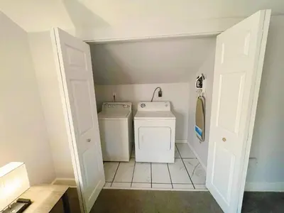 a laundry room with a washer and dryer at Cleveland Airport - 2nd Floor - WonDos Apartment in Cleveland