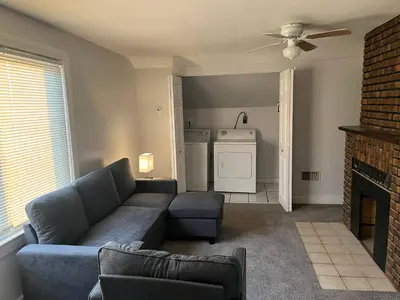 a living room with a couch and a fireplace at Cleveland Airport - 2nd Floor - WonDos Apartment in Cleveland
