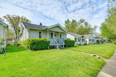 a house with a lawn in front of it at 3 Mi to Dtwn Fort Wayne Home with Deck and Yard! in Fort Wayne