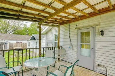 a patio with a table and chairs on a deck at 3 Mi to Dtwn Fort Wayne Home with Deck and Yard! in Fort Wayne