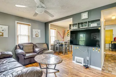 a living room with a couch and a table at 3 Mi to Dtwn Fort Wayne Home with Deck and Yard! in Fort Wayne