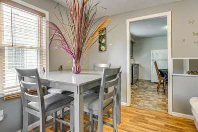 a kitchen and dining room with a table and chairs at 3 Mi to Dtwn Fort Wayne Home with Deck and Yard! in Fort Wayne