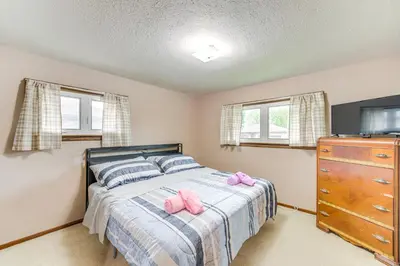 a bedroom with a bed with pink shoes on it at 8 Mi to Cleveland Family Home with Fenced Backyard! in Brooklyn