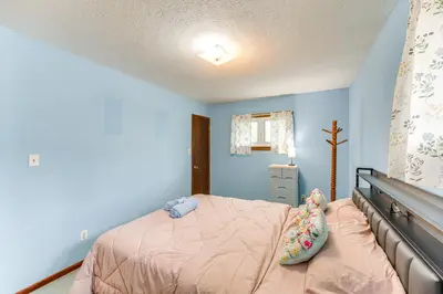 a bedroom with blue walls and a bed with pillows at 8 Mi to Cleveland Family Home with Fenced Backyard! in Brooklyn