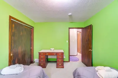 a room with a desk and a green wall at 8 Mi to Cleveland Family Home with Fenced Backyard! in Brooklyn