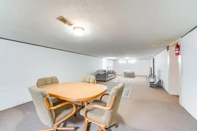 a dining room with a wooden table and chairs at 8 Mi to Cleveland Family Home with Fenced Backyard! in Brooklyn