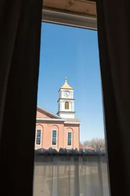 a view of a building with a clock tower from a window at Courthouse Suite - Room 1 in Versailles