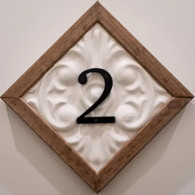 a sign with a number two in a wall at Courtyard Queen - Room 2 in Versailles