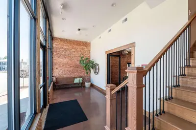 a hallway with stairs and a brick wall at Courtyard King - Room 3 in Versailles