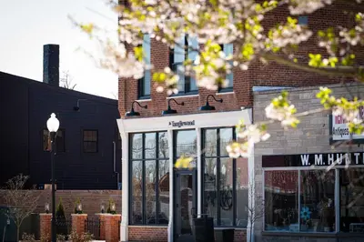 a store front of a brick building with windows at Courtyard King - Room 4 in Versailles